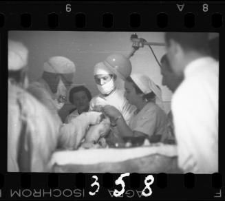 Doctors performing surgery on baby