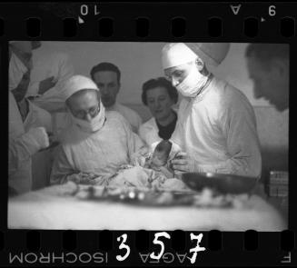 Doctors performing surgery on baby