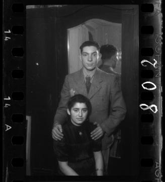 Portrait of a young couple, in front of a mirror, at a wedding in the ghetto