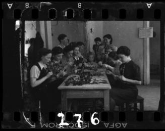 Women crafting decorations from scraps of fabric and leather in a workshop ("ressort") in the ghetto
