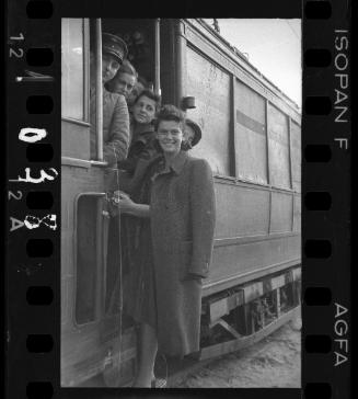Transport Department driver and women riding a train