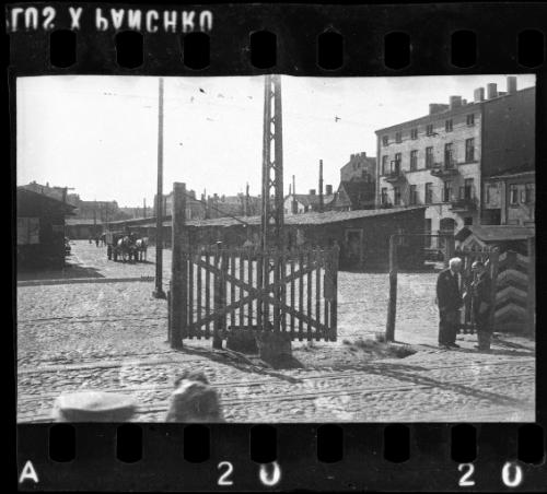Chaim Rumkowksi and an unidentified man [possibly a German official or a member of the Judenrat] beside an entry gate to the ghetto