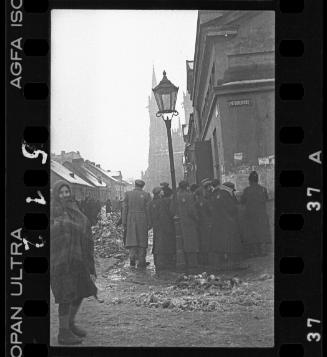 Residents gathered on a street corner in winter