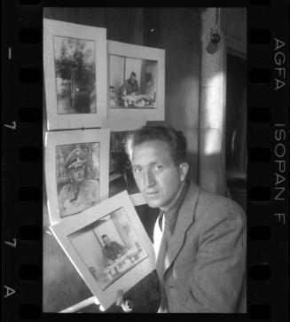 Mendel Grossman with portraits of German officers and administrators