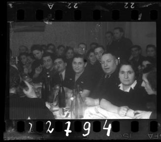 Residents sit around the table at a wedding reception in the ghetto
