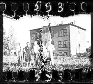 Ghetto residents in front of a three-storey building