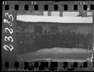 Large group of men and women workers and administrators of the Transport Department standing in the ghetto in winter
