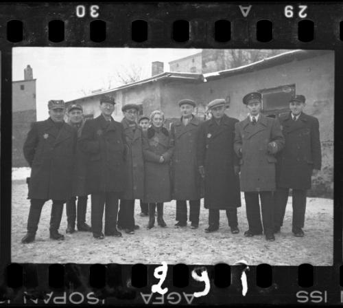 Workers of the Transport Department standing outside of a building in the winter