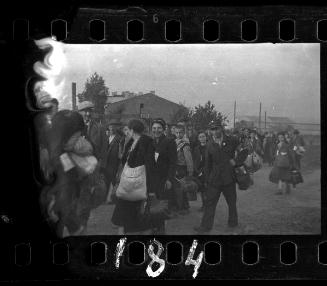 Massive deportation of residents escorted by ghetto policeman