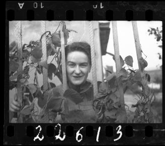 Young woman among vines