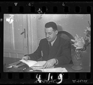 Administrator reading at his desk