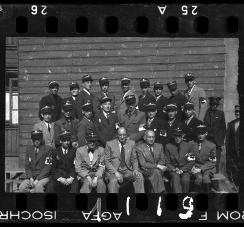 Group portrait of Jewish policeman and a member of the Transport Department outside an unidentified building