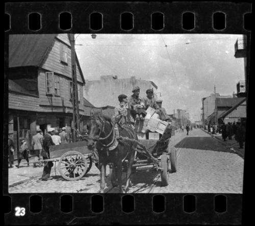 Residents transporting goods by horse-drawn wagon through the ghetto