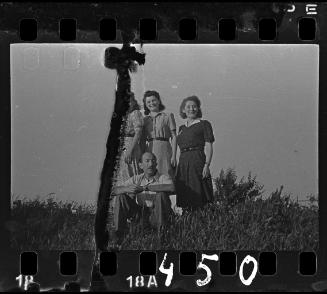 Three women and a seated man