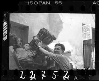 Male factory worker unloading mattress springs