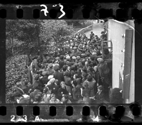 Mordechai Chaim Rumkowksi, "Elder of the Jews" and Chairman of the Judenrat, speaks to a crowd, surrounded by ghetto police
