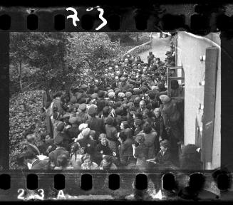 Mordechai Chaim Rumkowksi, "Elder of the Jews" and Chairman of the Judenrat, speaks to a crowd, surrounded by ghetto police