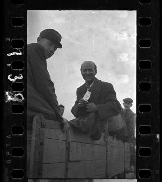 Man (tagged 869) and ghetto police on deportation wagon