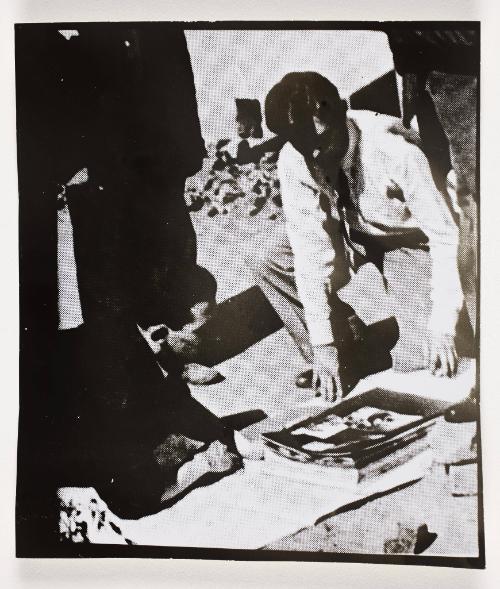 Henryk Ross and unknown man looking at photographs
