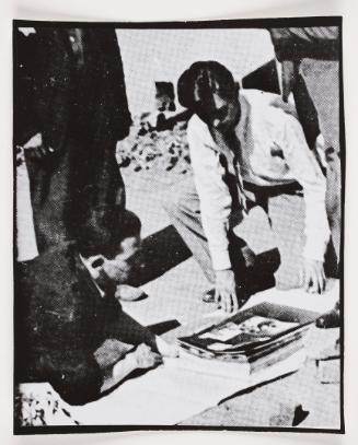 Henryk Ross and unknown man looking at photographs