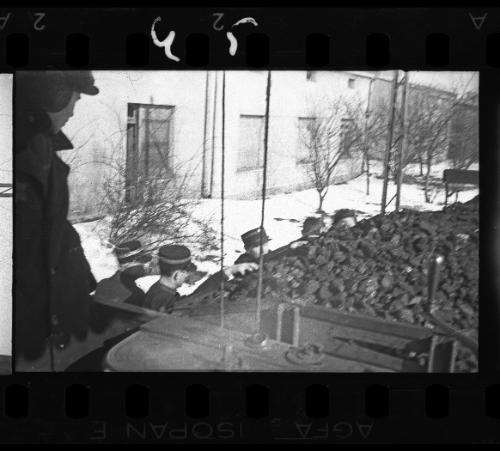 Policemen gathering coal