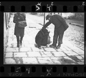 Giving a helping hand to a person fallen on street, Lodz Ghetto