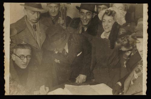 Henryk Ross and Stefania Schoenberg's wedding in the ghetto, with Ross signing a document