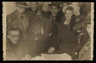 Henryk Ross and Stefania Schoenberg's wedding in the ghetto, with Ross signing a document