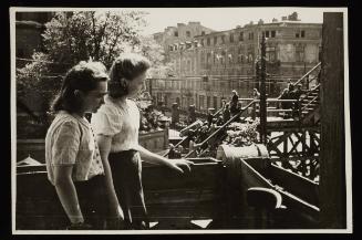 Two young women observing the bridge at Koscielyn Square, crossing Zigerska Street