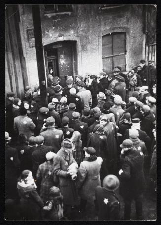 Residents gathered outside the doorway of building #44 in the ghetto
