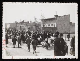 Group of residents walking in streets for deportation OR people moving into/out of Lodz Ghetto