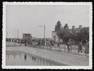 Mass deportation walking by water basin