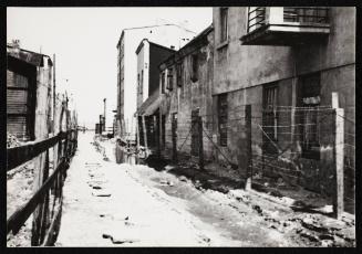 Ghetto street with barbed wire fence