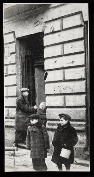 Two boys on the street, man in the backgroung getting a parcel