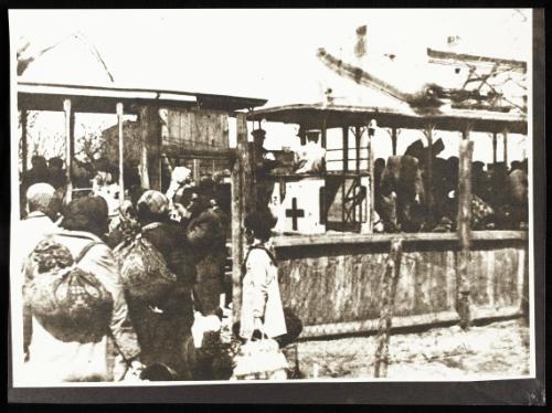 A woman being helped into the deportation train at Radogoszcz Station
