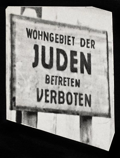 Sign: Wohngebiet der JUDEN betreten Verboten. “On the 8th of February 1940, 153 days after the German troops entered Lodz, police chief SS Brigadefuhrer Schaffer had posters put on the walls of the city announcing the establishment of the Ghetto, where all Jewish   inhabitants of Lodz had to be concentrated.” (p. 7)
