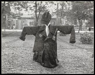 Scarecrow in a coat with a star of David
