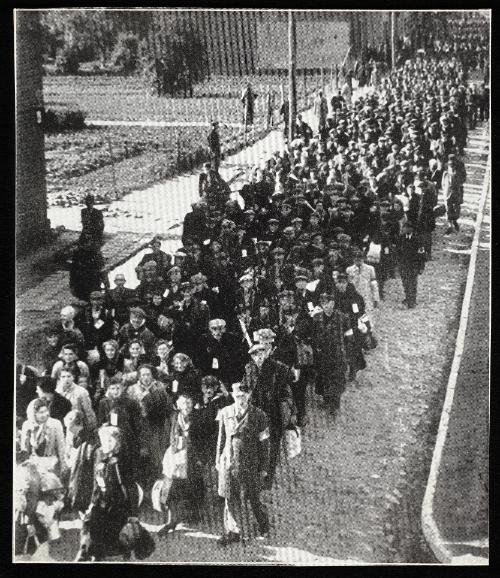 Throng of deportation turning at street corner (looking towards camera, from above)