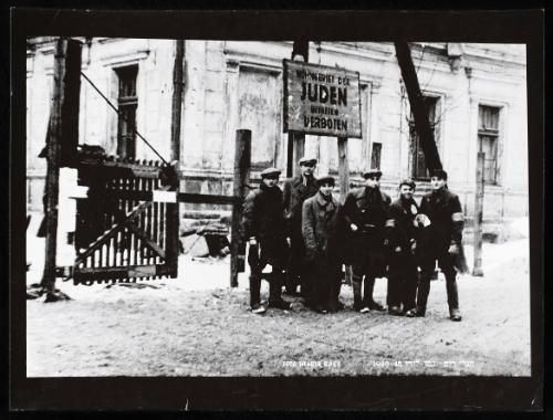 Lodz Ghetto liberated, residents standing freely at restricted Juden gate