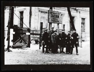 Lodz Ghetto liberated, residents standing freely at restricted Juden gate