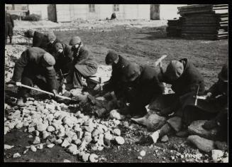 Workers breaking rocks