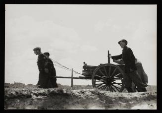 Two men pulling a cart, probably a hearse