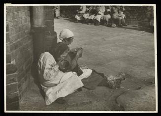 Women on street eating from pails
