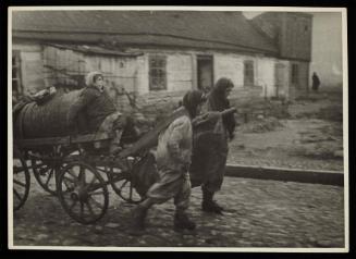Two women pulling fecal wagon