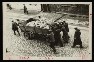 Men moving wagon with sacks, Lodz Ghetto