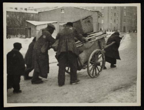 Ghetto residents hauling goods on cart