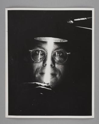 Science Works for Consumers: A scientist from the Oak Ridge National Laboratory holds a lamp devised to measure the smallest distances