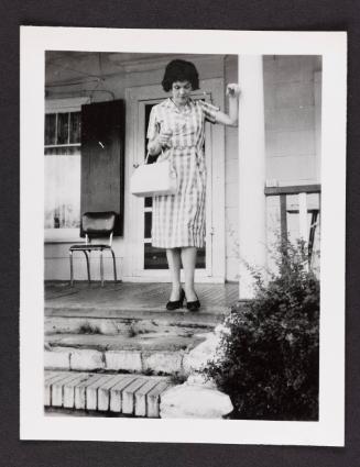 [Edith on the porch in gingham dress with white handbag, Chevalier d'Eon, Hunter, NY]
