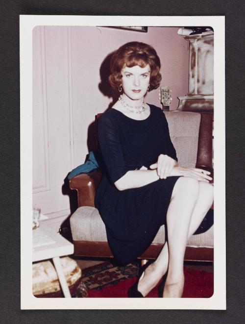 [Donna (Buff/Cynthia) in a navy dress in Susanna and Marie’s New York City apartment]
