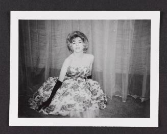 [Unnamed crossdresser sitting on the floor in a strapless dress and dark gloves on the stage at the Chevalier d’Éon, Hunter, NY]
